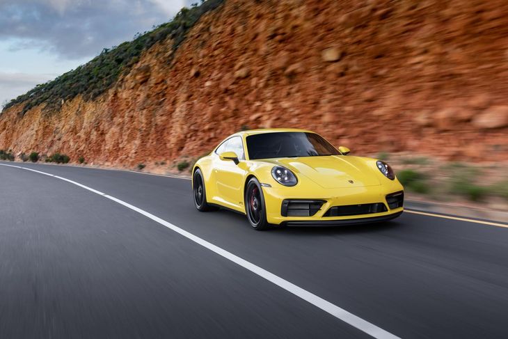 Porsche 911 GTS driving yellow