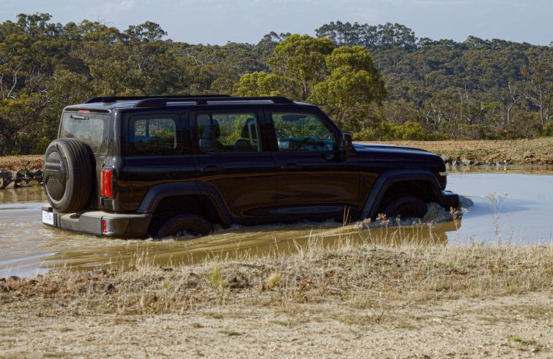 The GWM Tank 300 wading through water. It has a 600mm wading depth. 