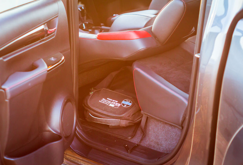 Hide a laptop case by storing it under the Toyota Hilux GR-S (GR-Sport) reclined front passenger seat. 