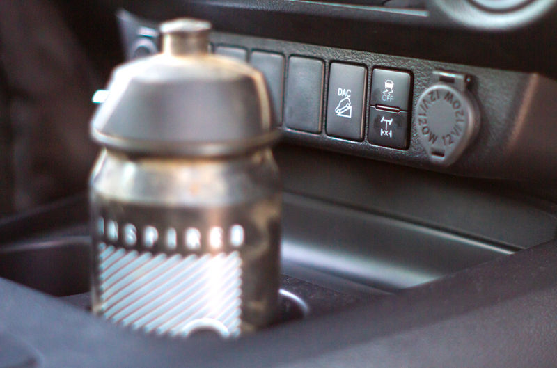 Contents of Toyota Hilux GR-S (GR-Sport) centre console cupholders may obscure differential lock and Downhill Assist Control buttons.