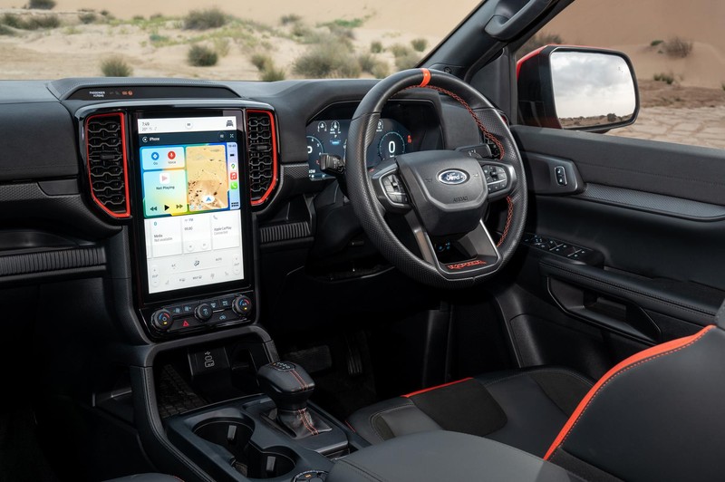 Ford Ranger Raptor's cabin with leather trim, red accents and portrait-style infotainment touchscreen.