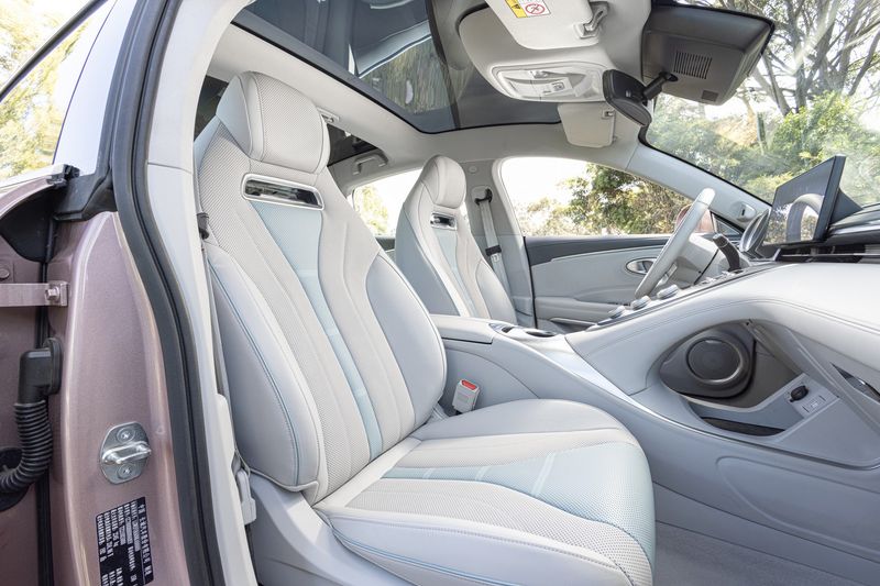 Contoured sports seats of the GWM Ora Sport. Also pictured: floating centre console with metallic knobs.