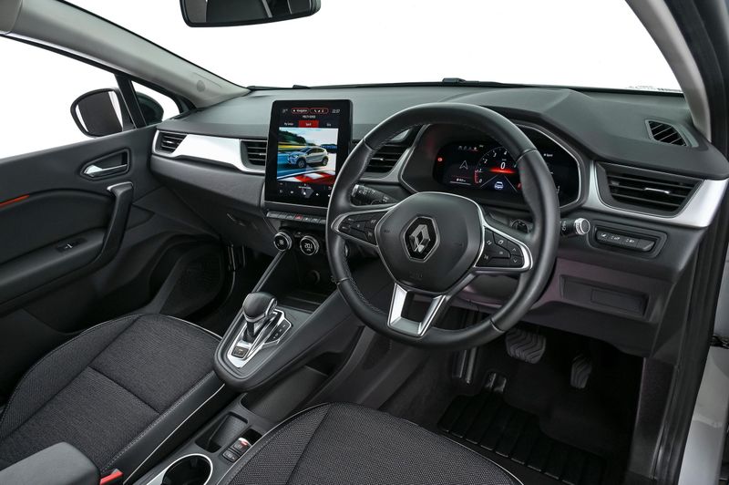 2023 Renault Captur fascia with large infotainment touchscreen and floating transmission console.