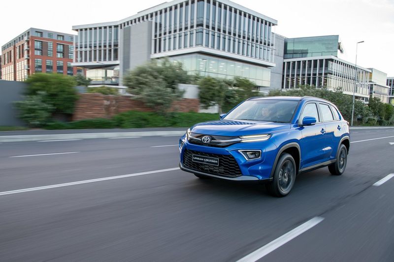 2023 Toyota Urban Cruiser driving on a multi-lane city road.